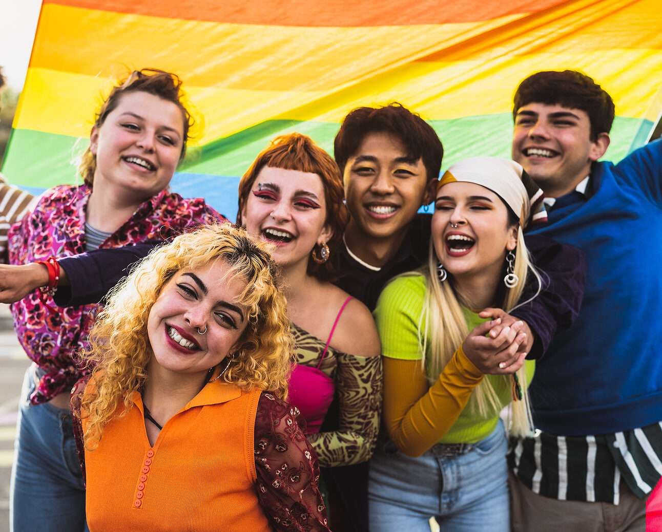 Happy diverse young friends celebrating gay pride festival - LGBTQ community concept